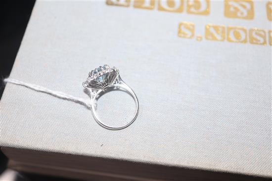 A modern 18ct white metal, aquamarine, baguette and round cut diamond set cluster ring, size K/L.